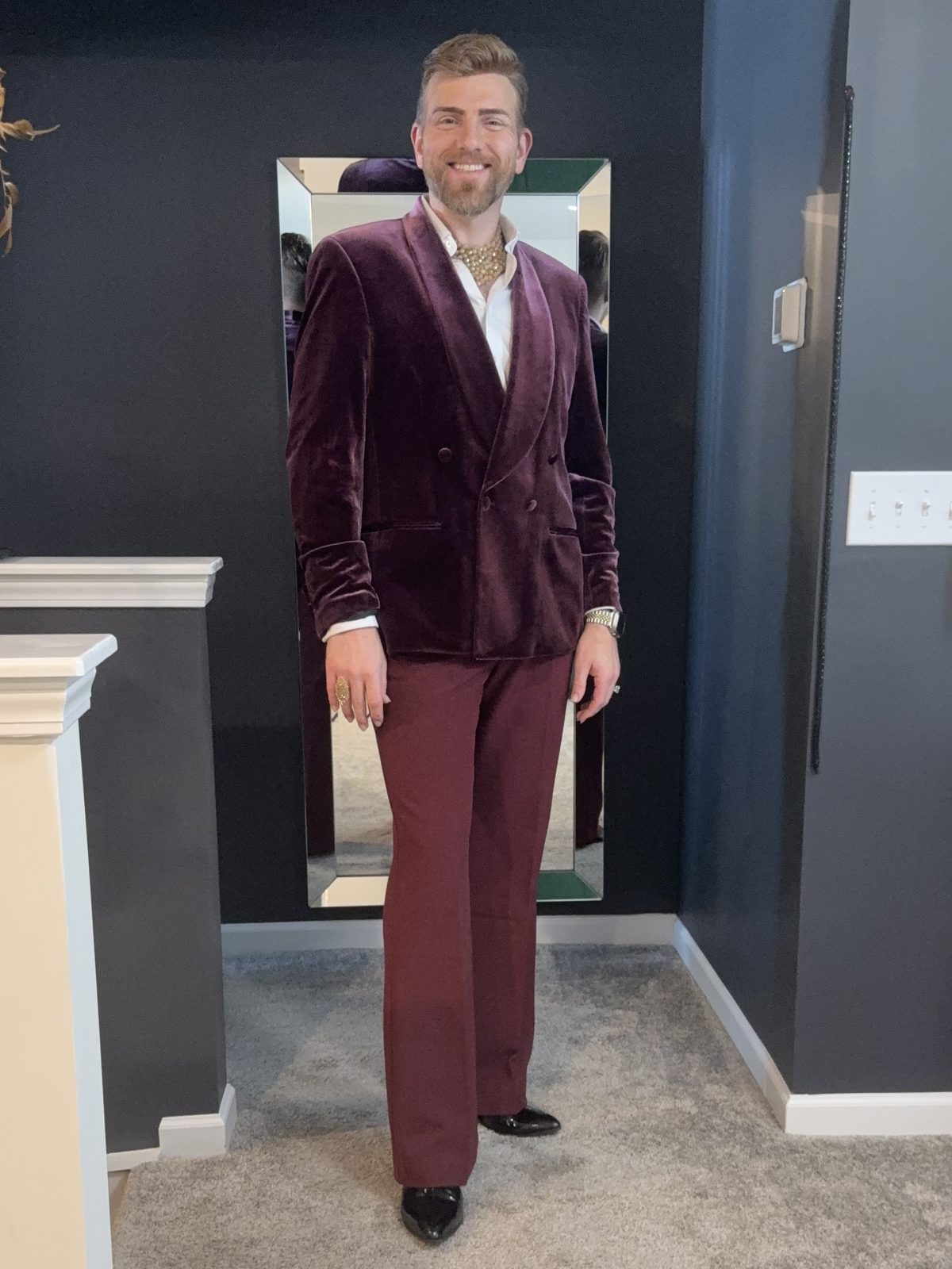 Stephen Aber in a full-length burgundy velvet double-breasted suit