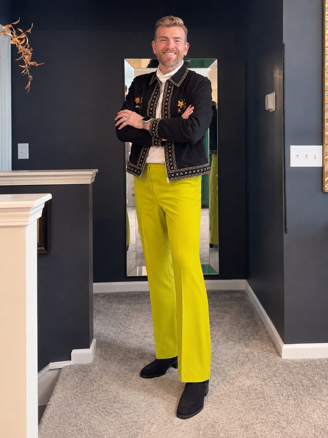 Stephen Aber in an embroidered black jacket with chartreuse flared trousers