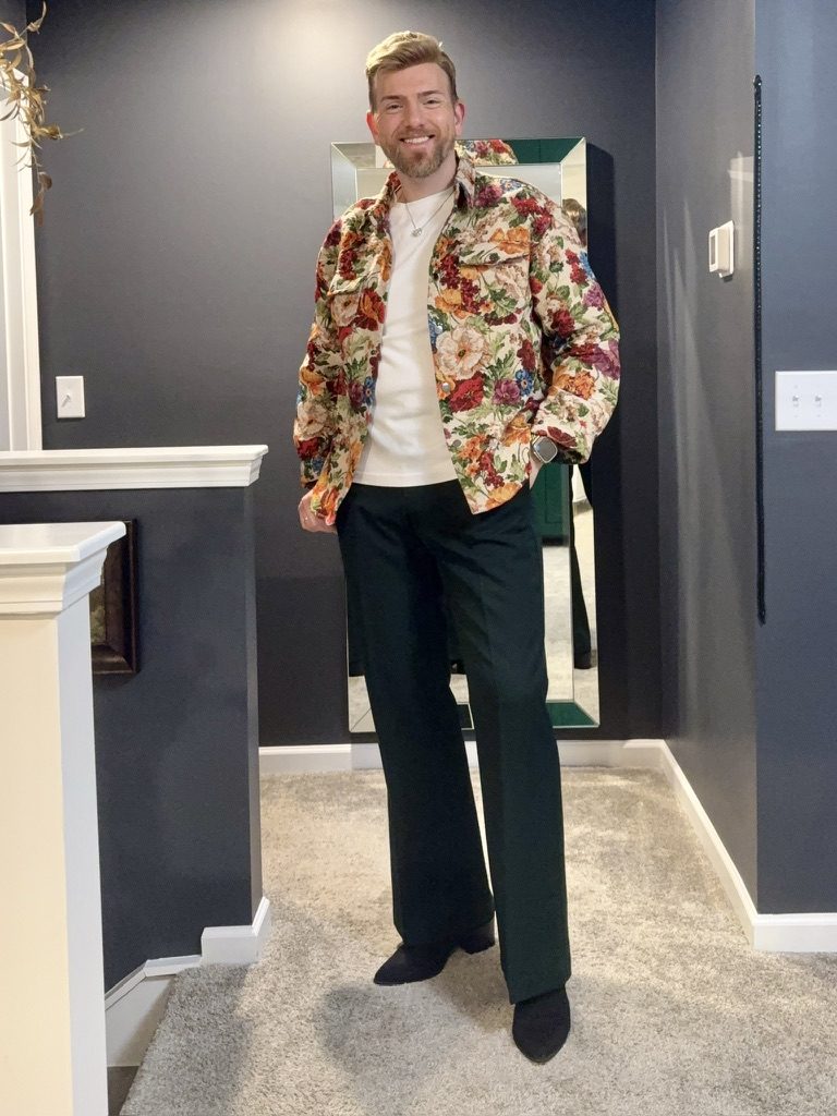 Stephen Aber in a floral tapestry jacket with dark green flared trousers